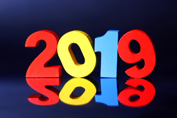 Wooden color numbers 2019 with reflection.