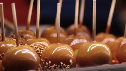 Caramel apples behind glass close up