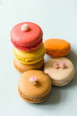 Colorful french macaroons on the blue table