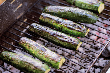 Fresh Green Zucchini Marinated With Garlic And Green Dill Herb, Salt And Back Pepper Cooking On Outdoor BBQ Grill