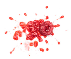 Smashed raspberries isolated on white