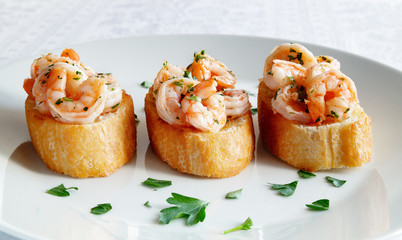 fried toast with fried in garlic oil shrimps decorated with parsley