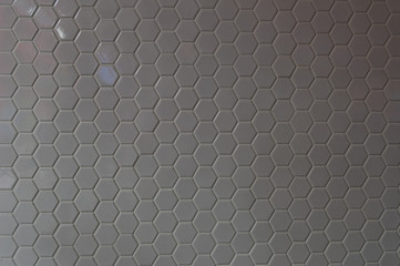 Fototapeta na wymiar A simple white texture pattern of hexagons as a background