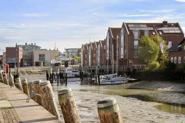 inner harbor at low tide in the old town of Husum on a sunny day, north sea coast in germany