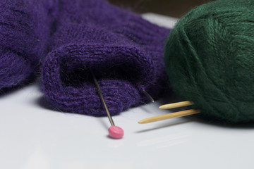 Tangle thread for knitting. Knitting needles are stuck into it.