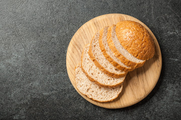 Fototapeta na wymiar Fresh sliced bread on wooden cutting board
