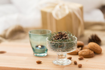 christmas concept - decoration of fir twig with pinecone in ice cream glass or dessert bowl