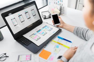 app design, technology and business people concept - web designer or developer with smartphone and...