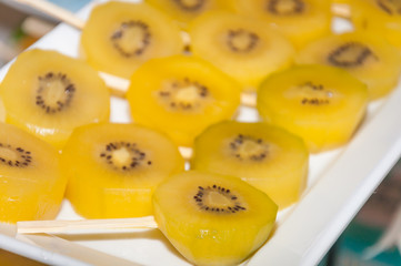 Fresh yellow sliced kiwi fruit for a healthy diet background with selective focused point