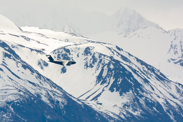 C-17 airplane in turn against snowy mountains