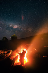 campfire with starry sky and Milky way at night