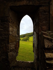 Old Arch Window in Castle Ruins with Scenic Countryside View