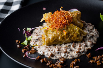 golubtsi Cabbage with rice and meat on a plate of buckwheat and carrots