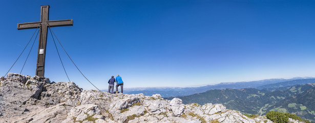 Fototapeta premium Two hikers enjoy beautiful view from summit of mountain Hochlantsch