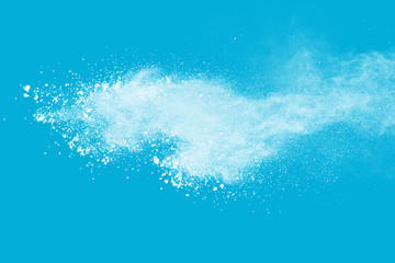 White powder explosion isolated on blue background. 