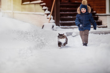 boy running with fluffy cat