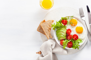 healthy breakfast flat lay. fried eggs, avocado, tomato, toasts