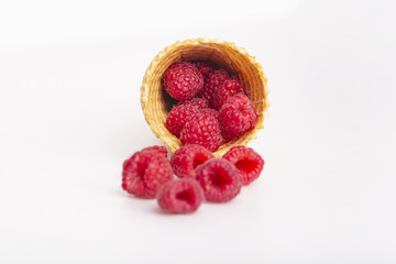 Ice cream or delicious dessert made from fresh raspberry berries on white background. Raspberry in a waffle cone. Summer, freshness, and the concept of the sweet menu.