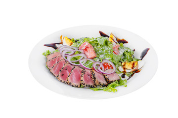 Salad with roast beef with onion, boiled eggs, tomatoes and balsamic vinegar, sauce on plate, white isolated background Side view. For the menu, restaurant, bar, cafe