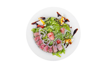 Salad with roast beef with onion, boiled eggs, tomatoes and balsamic vinegar, sauce on plate, white isolated background, view from above, for the menu, restaurant, bar, cafe