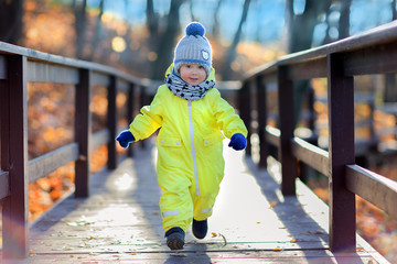 boy running on the wooden bridge