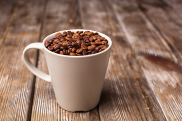 A cup filled with coffee beans