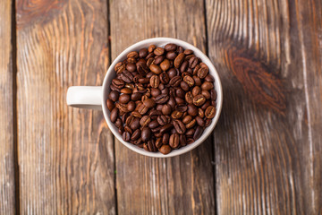 A cup filled with coffee beans