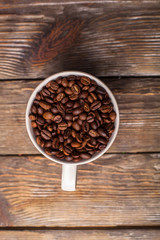 A cup filled with coffee beans