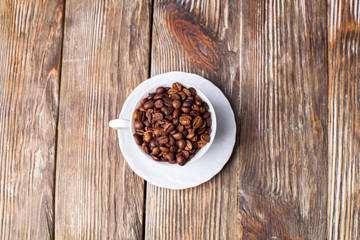 Coffee cup filled with coffee beans