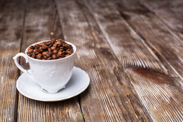 Coffee cup filled with coffee beans