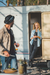 selective focus of girl with glass of wine looking at boyfriend
