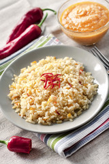 Spicy parboiled rice with carrots, yellow zucchini and chilli peppers