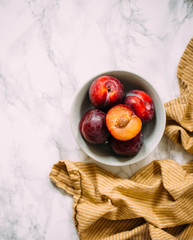 Plum on white marble background