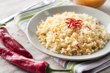 Spicy parboiled rice with carrots, yellow zucchini and chilli peppers