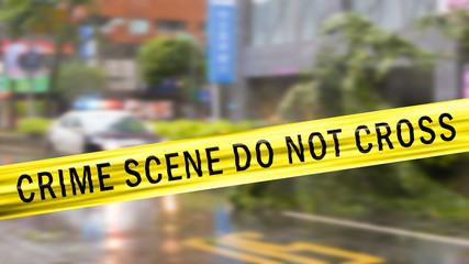 Obraz premium Boundary Tape and defocused squad car at Crime scene