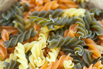 multicolor spiral macaroni top view surface close up texture background