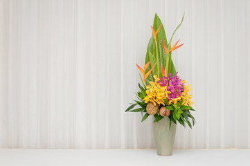 Colorful flowers bouquet in a vase on white background