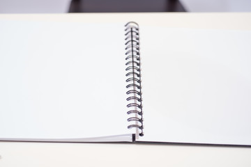 White notebook open page on the table, selective focus