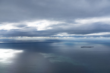 Aerial view from plane of sea and cloud with reflections near Punta Arenaa, Patagonia, Chile 