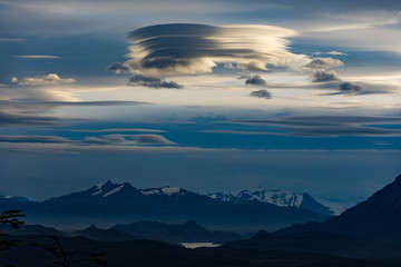 Lenticular clouds over the Andes taken from Torres del Paine, Patagonia, Chile at sunset in twilight.
