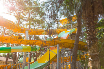 Vicky beautiful multi-colored water slide on the blue sky background. Fragment slides in the water park