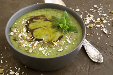 Vegetarian soup of green vegetables on a dark background.