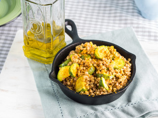 Buckwheat with zucchini and turmeric in cast iron skillet. Easy and healthy lunch for celiac gluten free diet