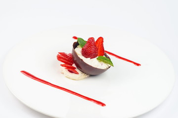 Strawberry mousse with mint on a white plate