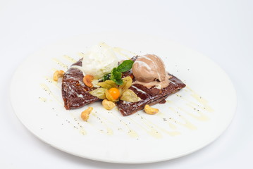 chocolate pancakes with ice cream on a white plate
