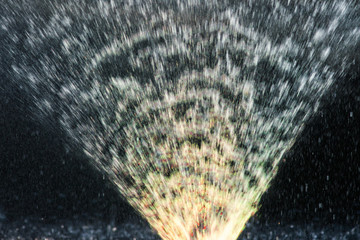 Illuminated water jets. Yellow color