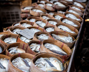 steam mackerel in bamboo wooden tray laid down for sales with price tag