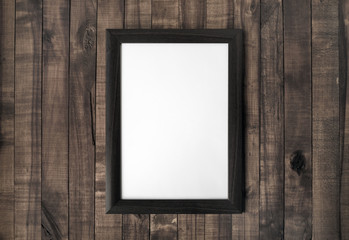 Blank frame or photo frame on vintage wood background. Responsive design mockup.