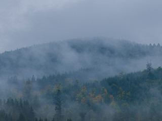 The Carpathian mountains landscape during mist in the autumn season