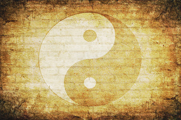 Chinese yin yang sign on an old brick wall